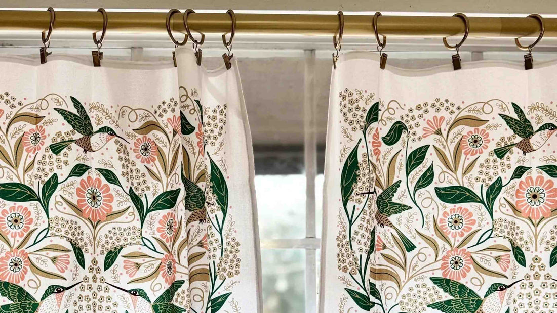 Monarch Garden Cafe Curtains by Gingiber — hung on a brass rod in a sunlit kitchen window