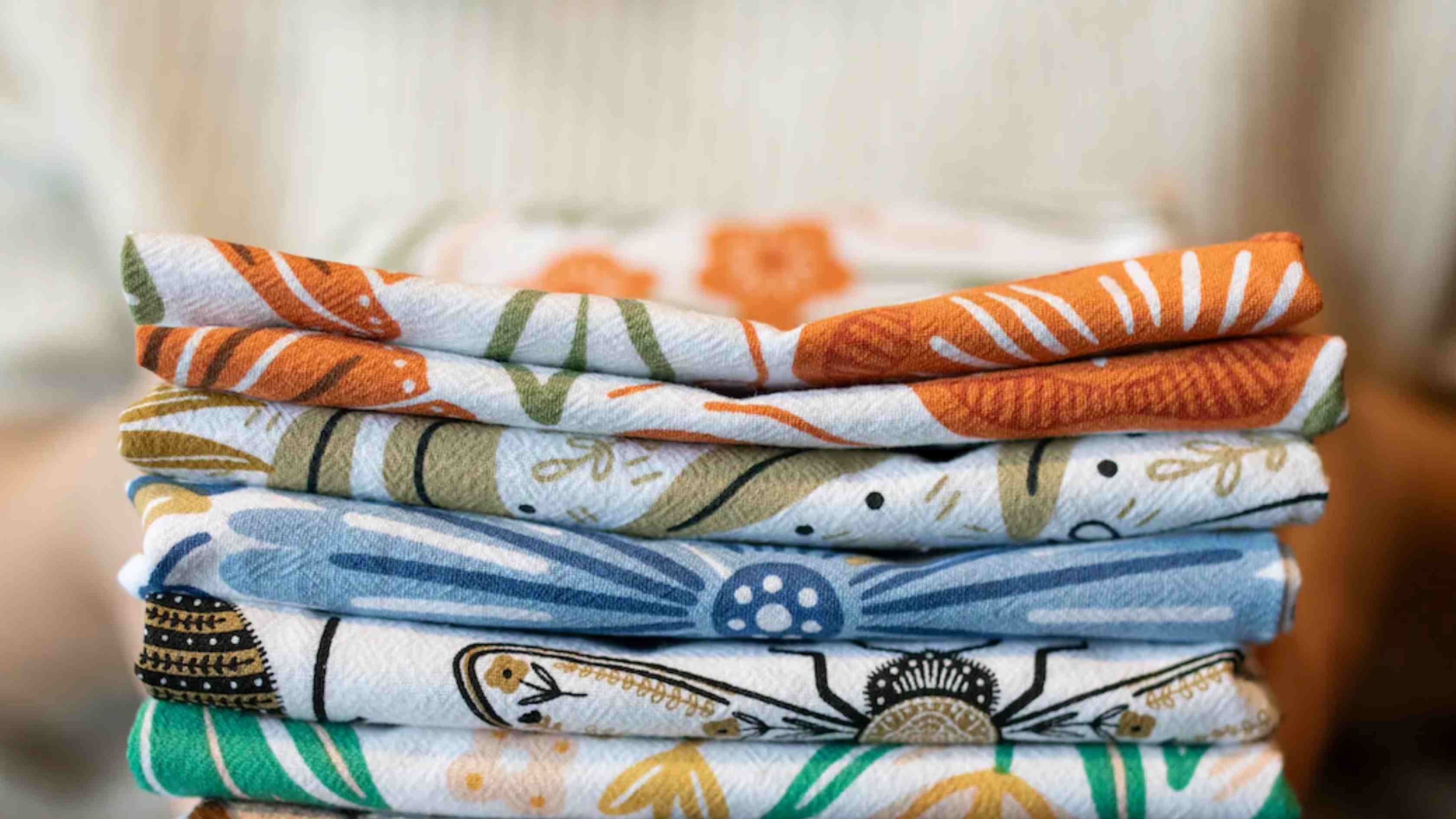 Illustrated tea towel by Gingiber — a birthday subscription gift tied with a ribbon