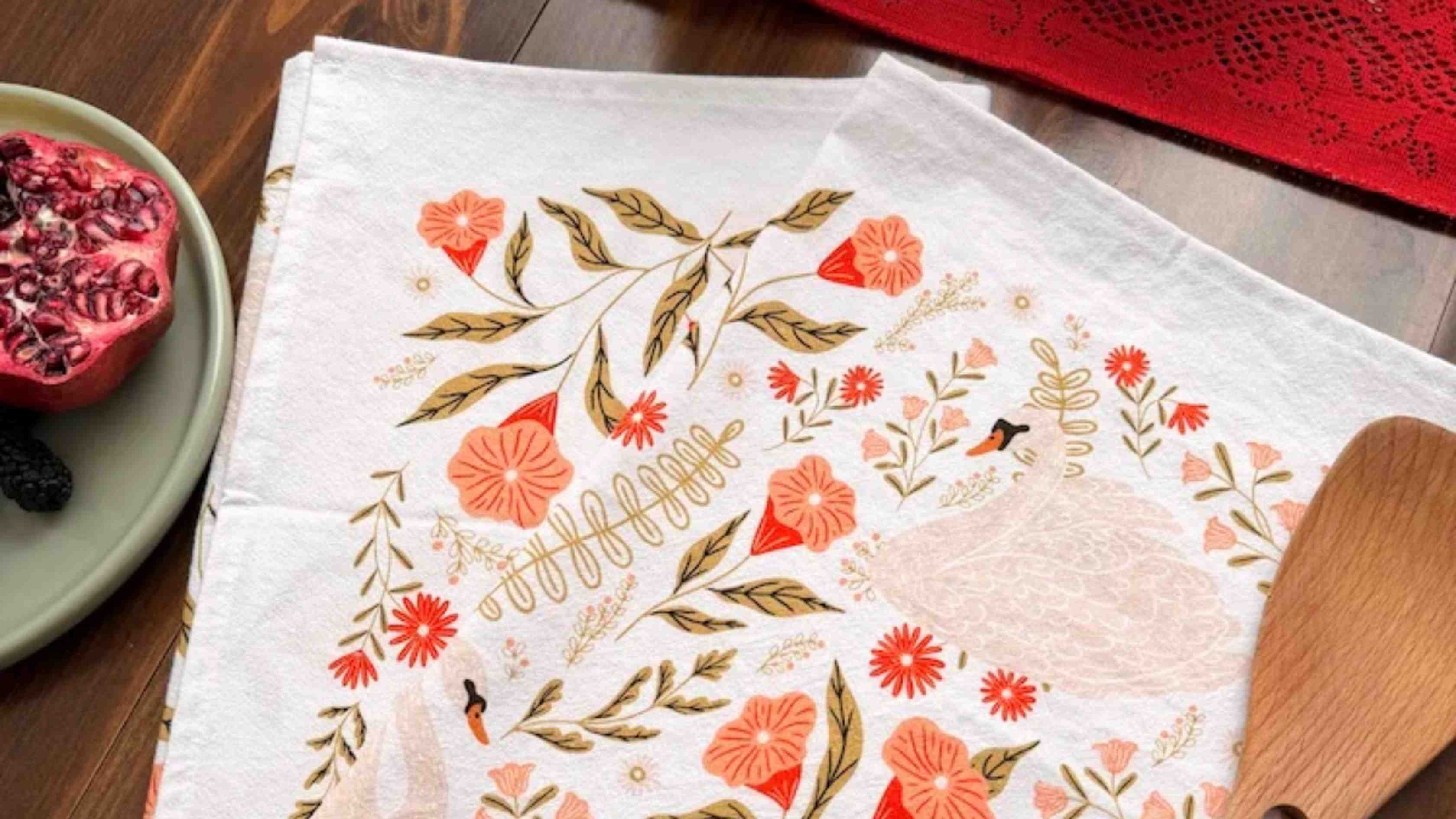 Swan Serenade Floral tea towel by Gingiber folded with a greeting card as an affordable thoughtful gift under $25