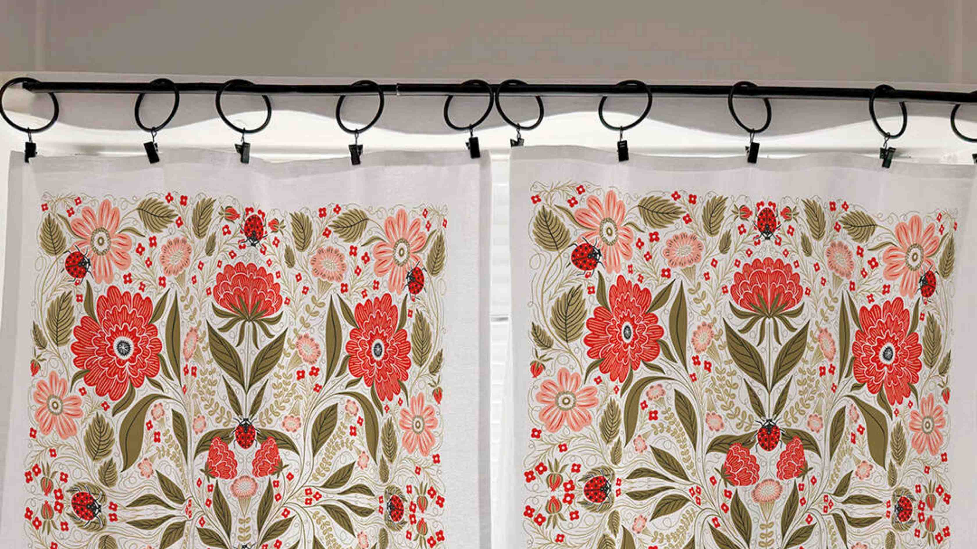 Ladybug Cafe Curtains by Gingiber hung on a tension rod in a bright kitchen window without drilling