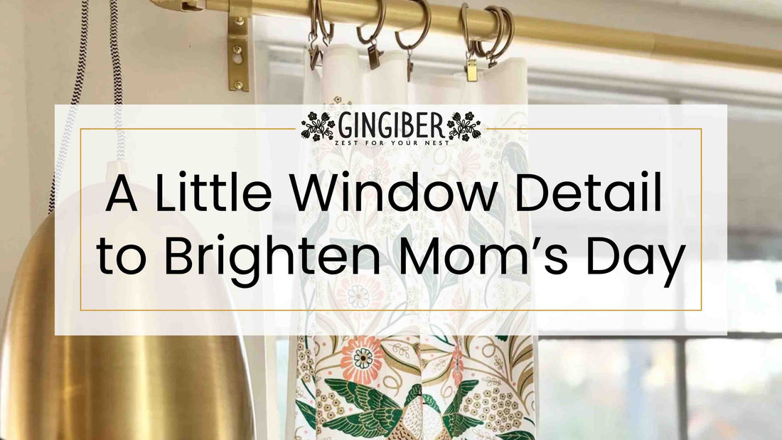 Lilac floral café curtains with soft purple blooms and green leaves hanging on black rings, filtering natural light to brighten a cozy kitchen window for Mother’s Day.