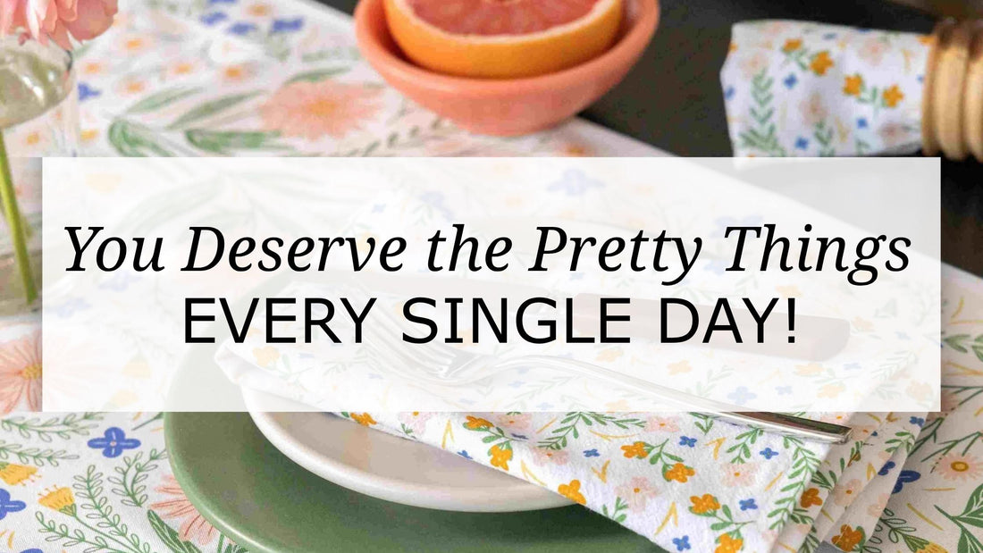 Wildflower table runner and napkin styled with layered plates and citrus, with overlay text “You Deserve the Pretty Things Every Single Day,” capturing a warm, intentional everyday dining moment.