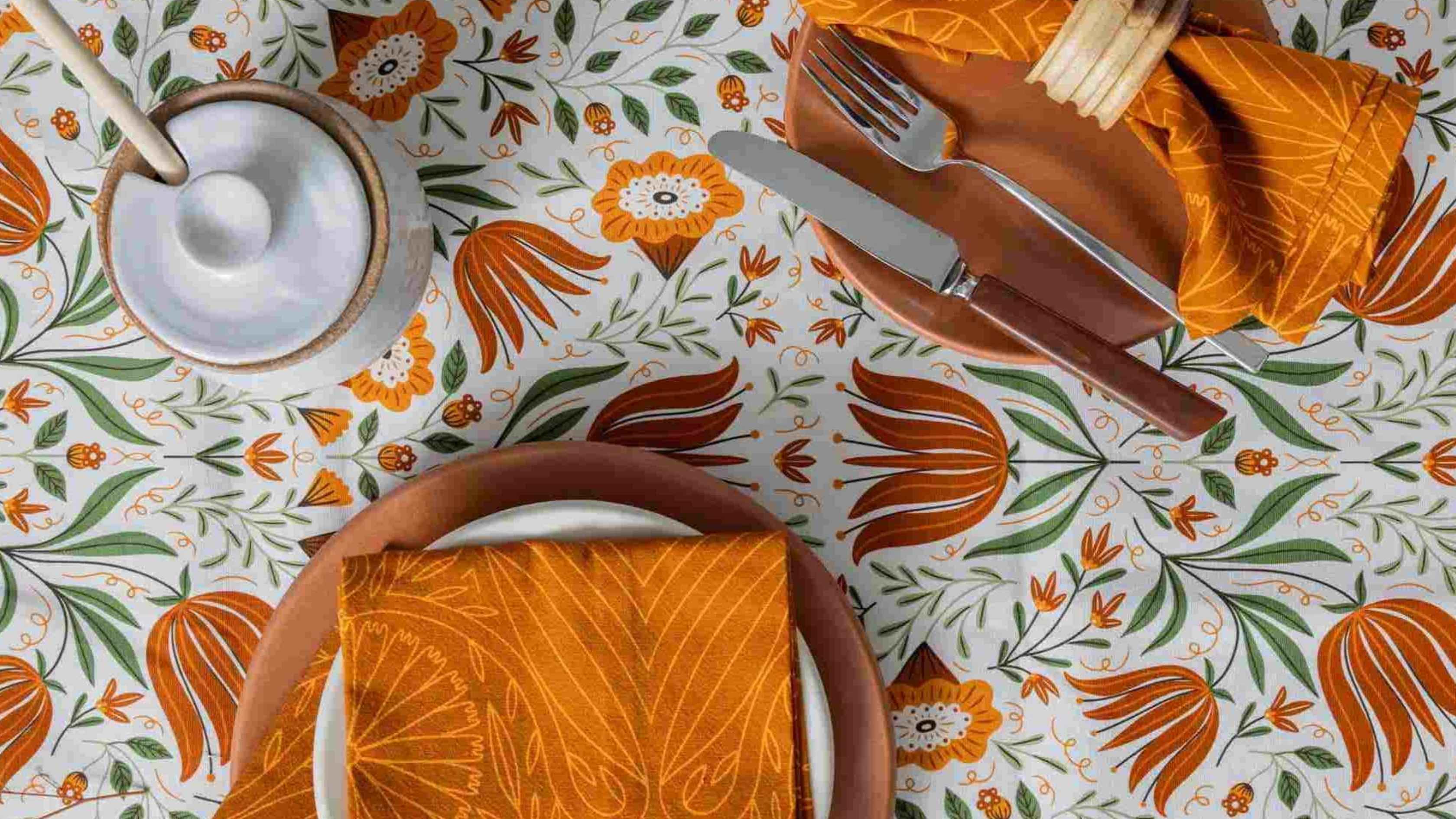 Orange Flower Lines Napkins featuring warm orange botanical line art, styled on a colorful floral table setting with earthy dinnerware and silverware for an affordable, polished kitchen and dining look.
