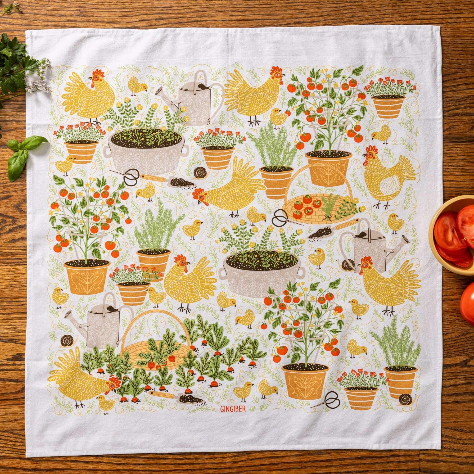 tea towel with illustrated chickens and garden items 
