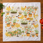 tea towel with illustrated vegetables, chickens, and garden details
