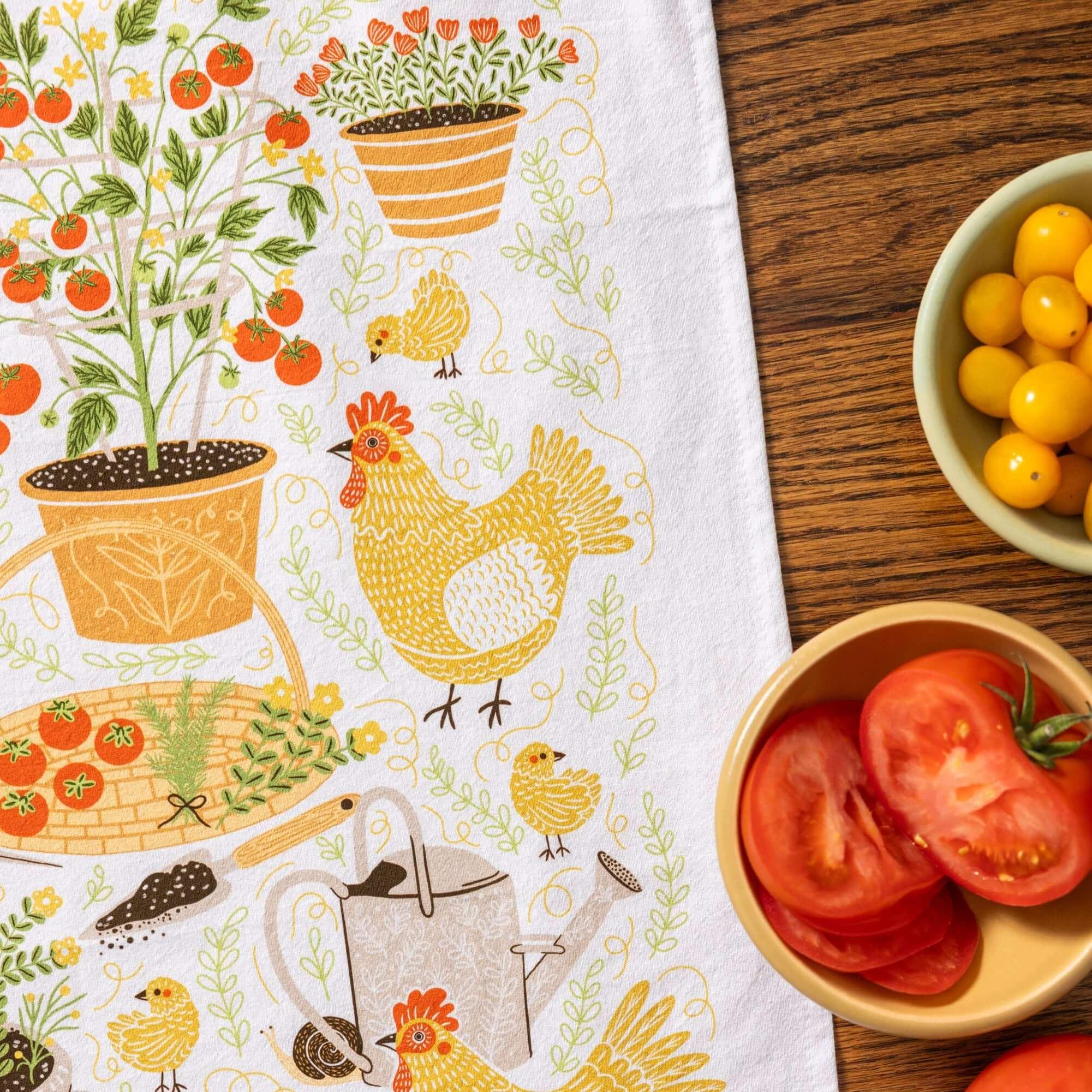 tea towel with illustrated chickens and garden items 