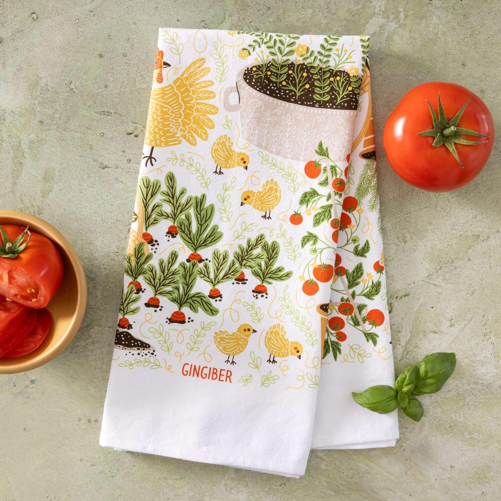 tea towel with illustrated chickens and garden items 