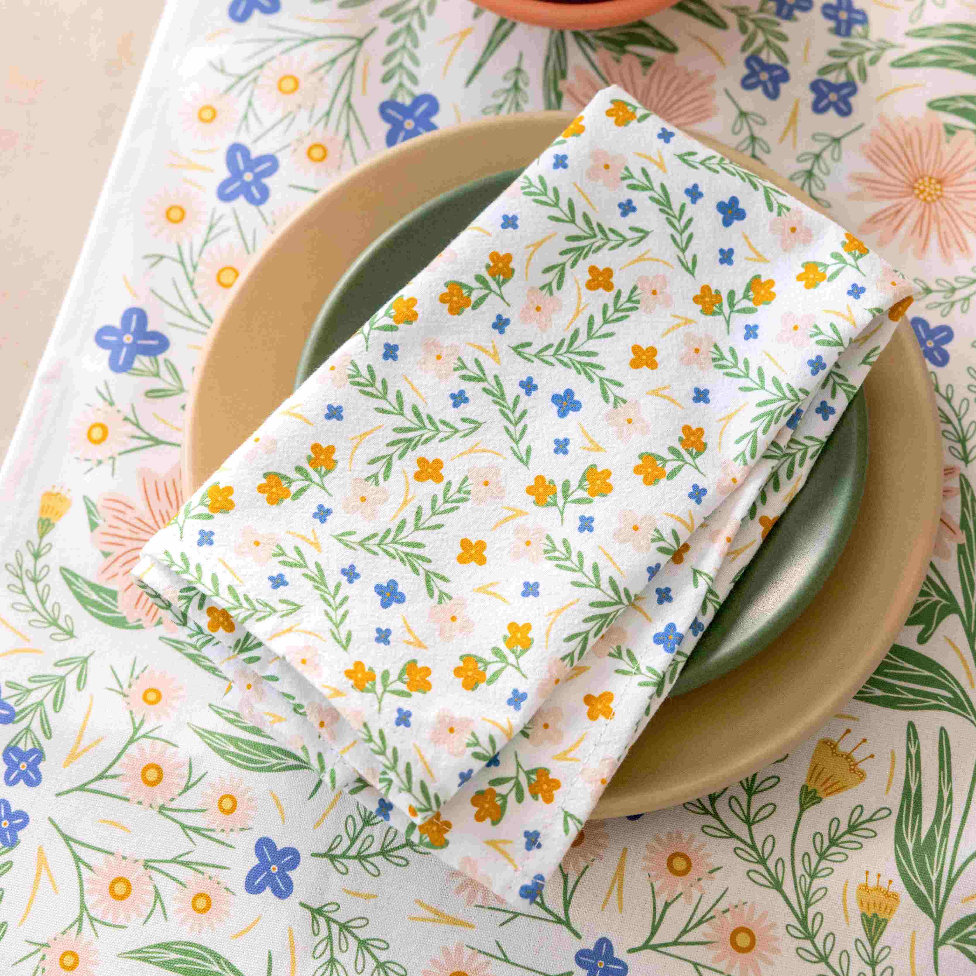 Floral-patterned napkin on a plate with a matching floral tablecloth