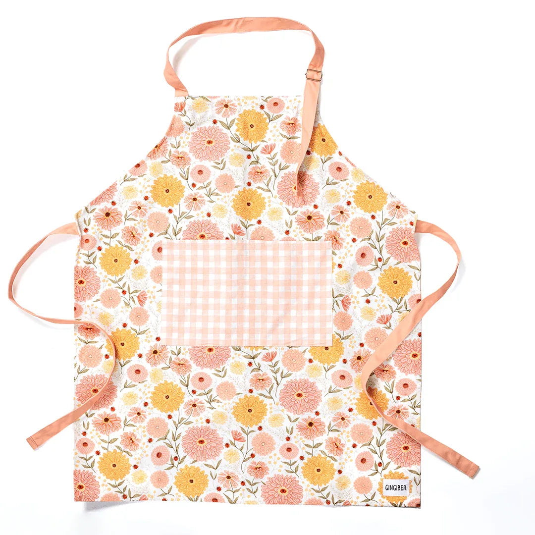 Zinnia Apron and Tea Towel Bundle featuring floral design and large pocket for kitchen use.
