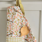 Apple Blossom Apron - Gingiber design with birds and pink blossoms, adjustable neck strap, front pocket, 100% cotton canvas, one size