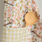 Apple Blossom Apron and Tea Towel Bundle featuring floral design and wooden spoon in pocket.