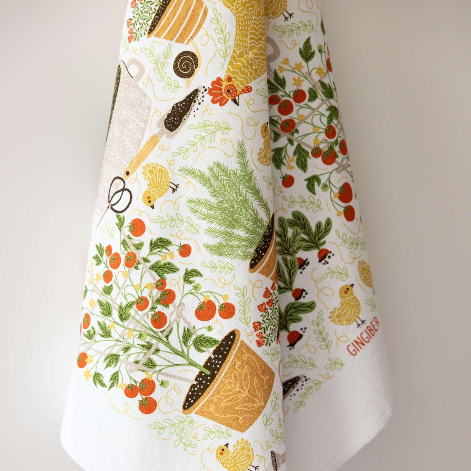 tea towel with illustrated chickens and garden items 