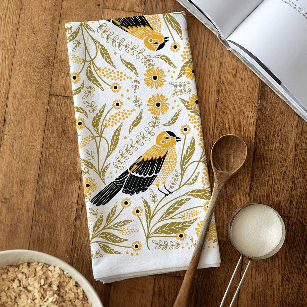 tea towel with illustrated birds and floral elements