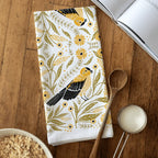 tea towel with illustrated birds and floral elements