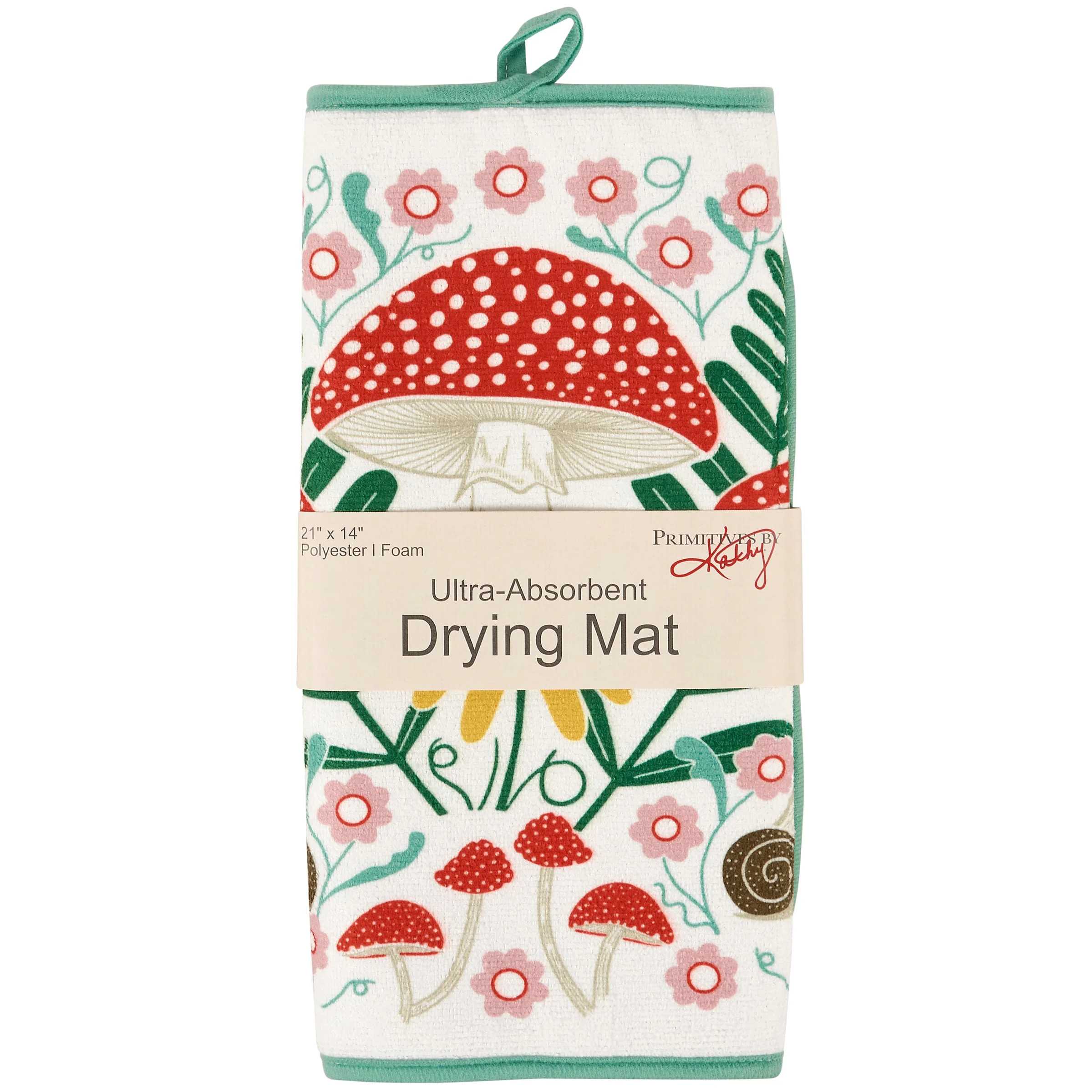 A packaged drying mat with a white background and colorful mushroom and floral print. The mat is wrapped in a paper band labeled 'Ultra-Absorbent Drying Mat' with the brand name 'Pimkie' visible on the band.