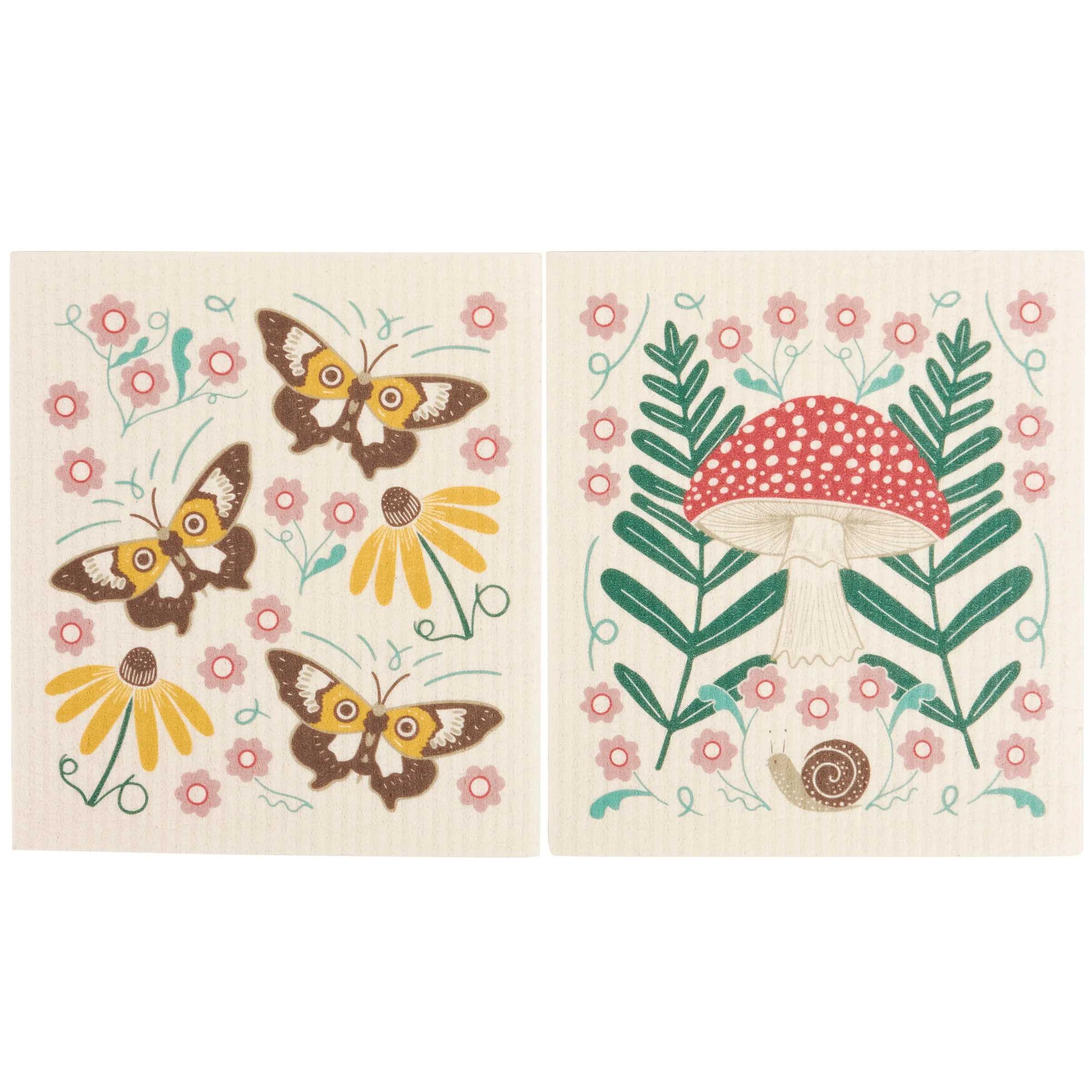 Two square decorative kitchen towels or placemats with embroidered-style woodland motifs on a cream background. The left panel shows four brown-and-yellow butterflies with pink flowers and yellow daisies.