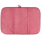 Pink textured drying mat on a white background