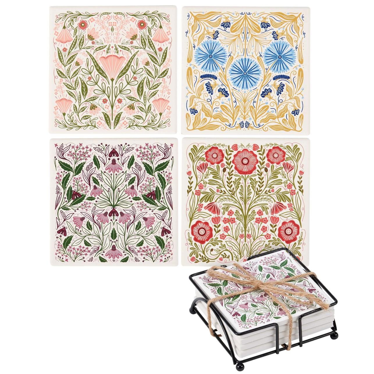 Set of four floral coasters with a holder on a white background