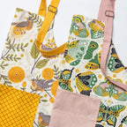 Apron - Gingiber floral apron with adjustable neck strap, large pocket, cotton canvas, 29" L x 26" W, tie back, 100% cotton, imported