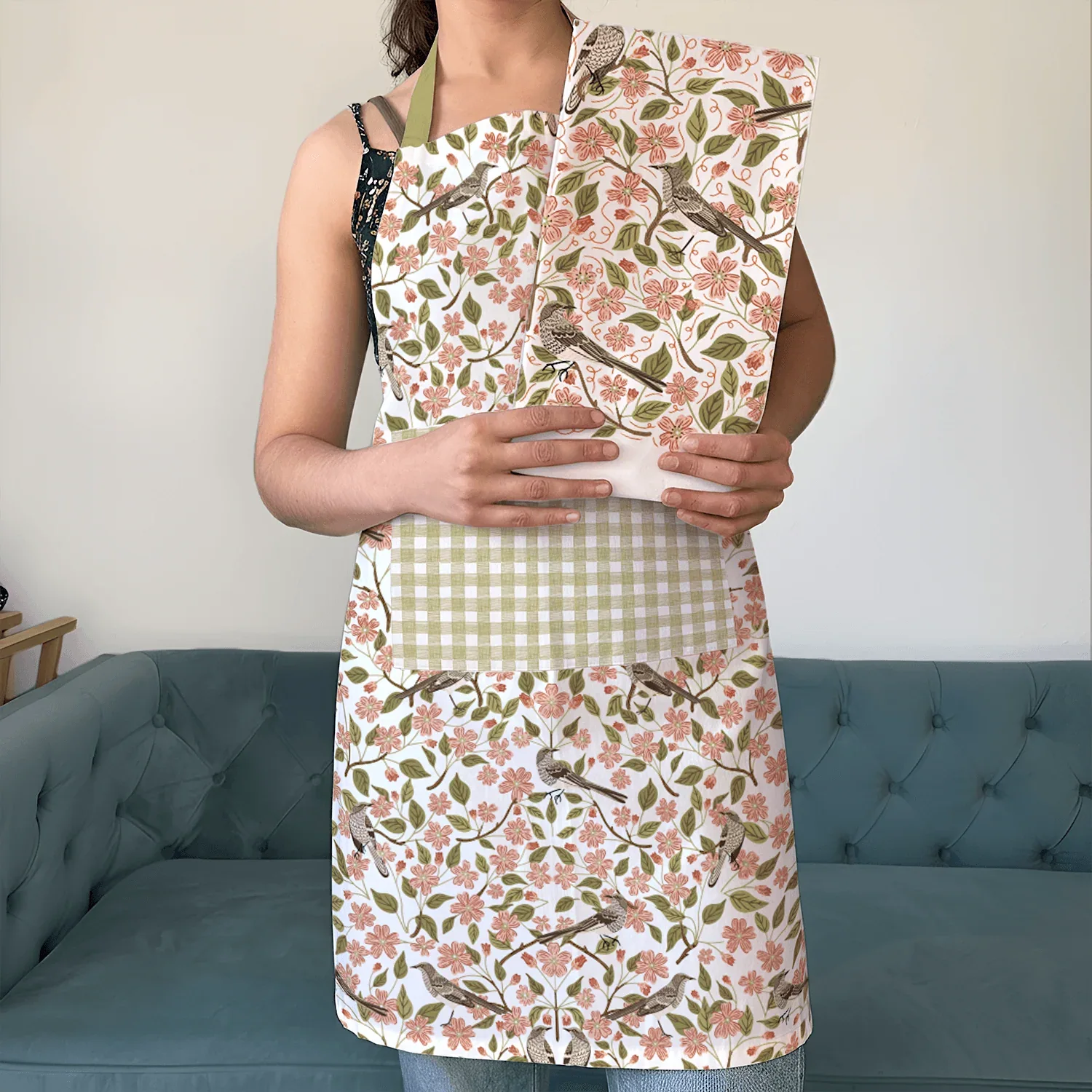 Apple Blossom Apron and Tea Towel Bundle - person wearing floral apron and matching tea towel bundle with checkered pocket, indoor setting