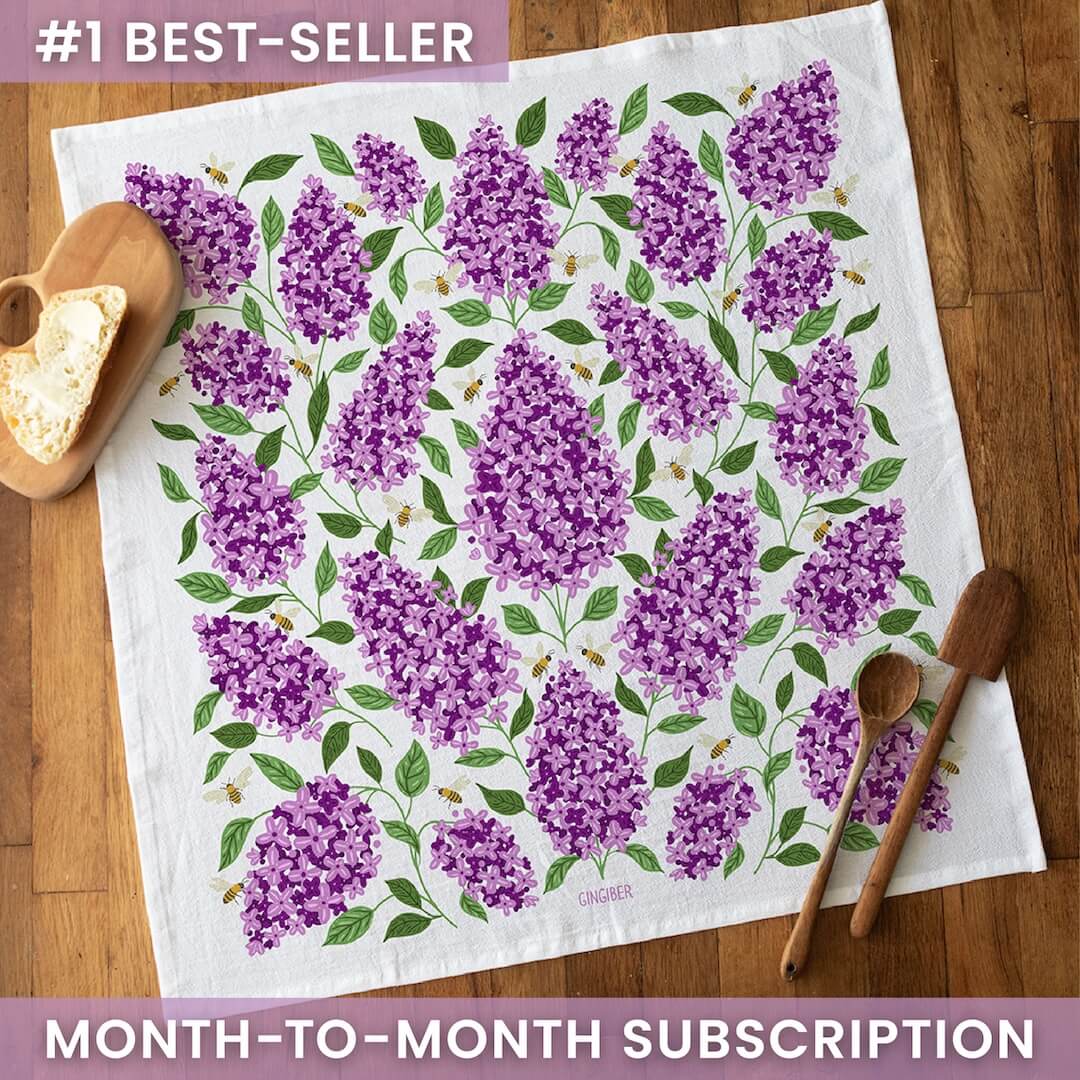 Floral patterned towel on a wooden surface with text about a subscription offer.