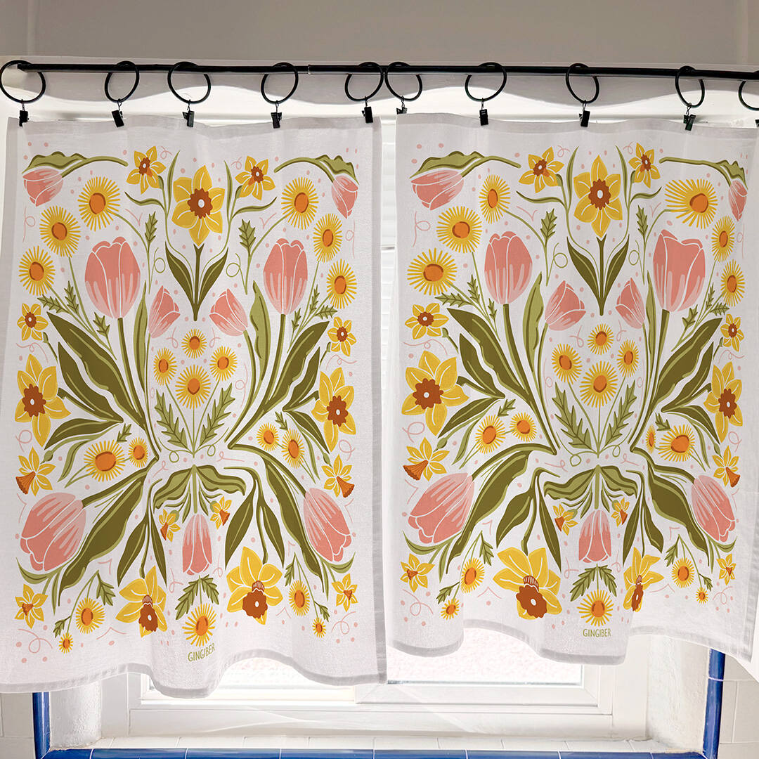 Floral patterned curtains hanging on a rod with a tiled wall background.