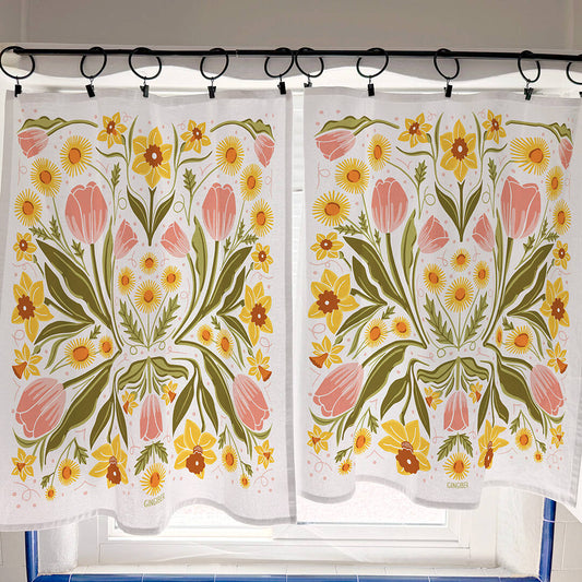 Floral patterned curtains hanging on a rod with a tiled wall background.