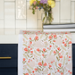 Decorative table runner with floral and swan pattern on a kitchen counter.