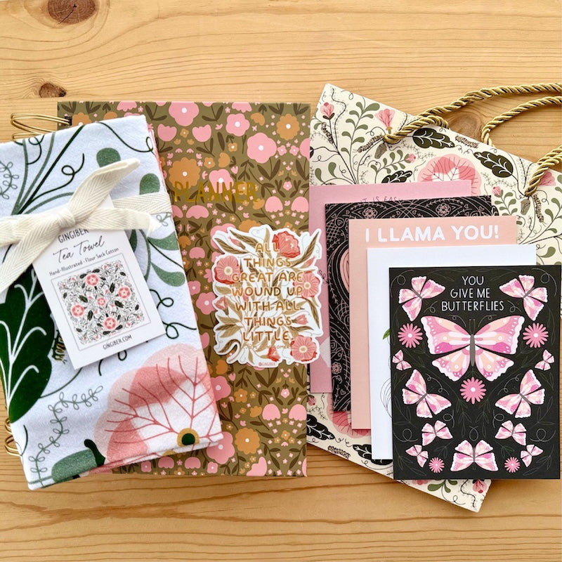 Collection of floral and nature-themed greeting cards on a wooden surface