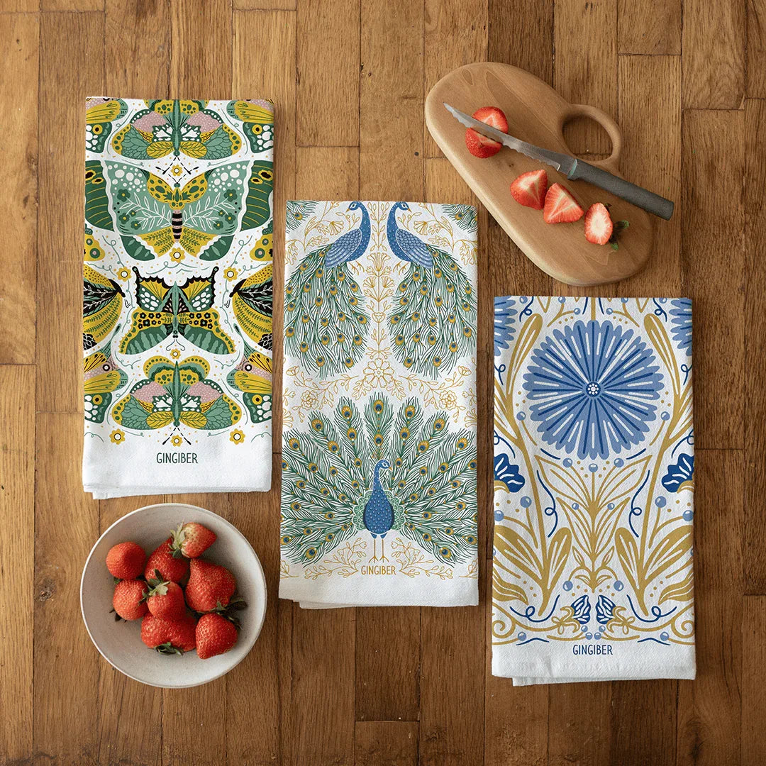 tea towel bundle with illustrations of peacocks, butterflies, and floral elements
