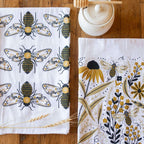 tea towel with illustrated bees and floral elements