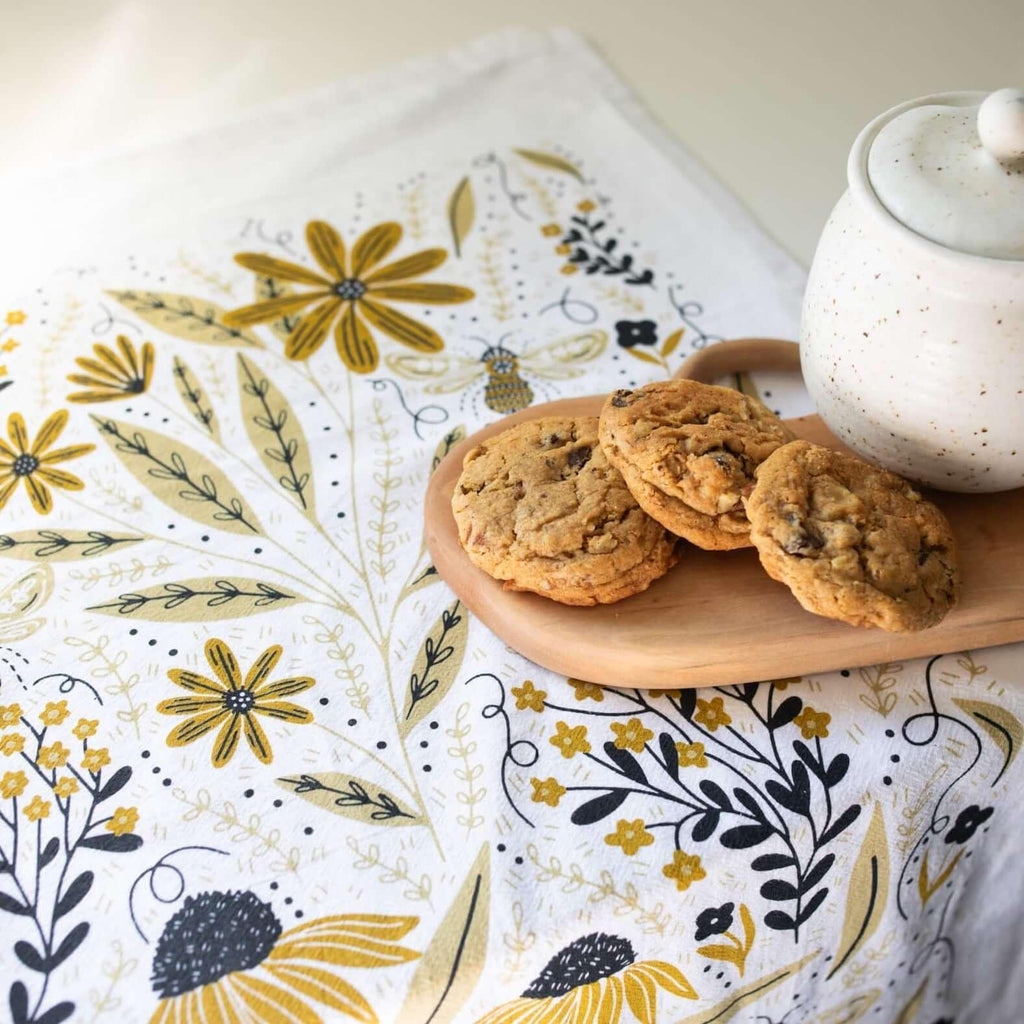 tea towel with illustrated bees and floral elements