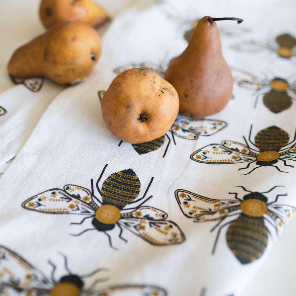 tea towel with illustrated bees and floral elements