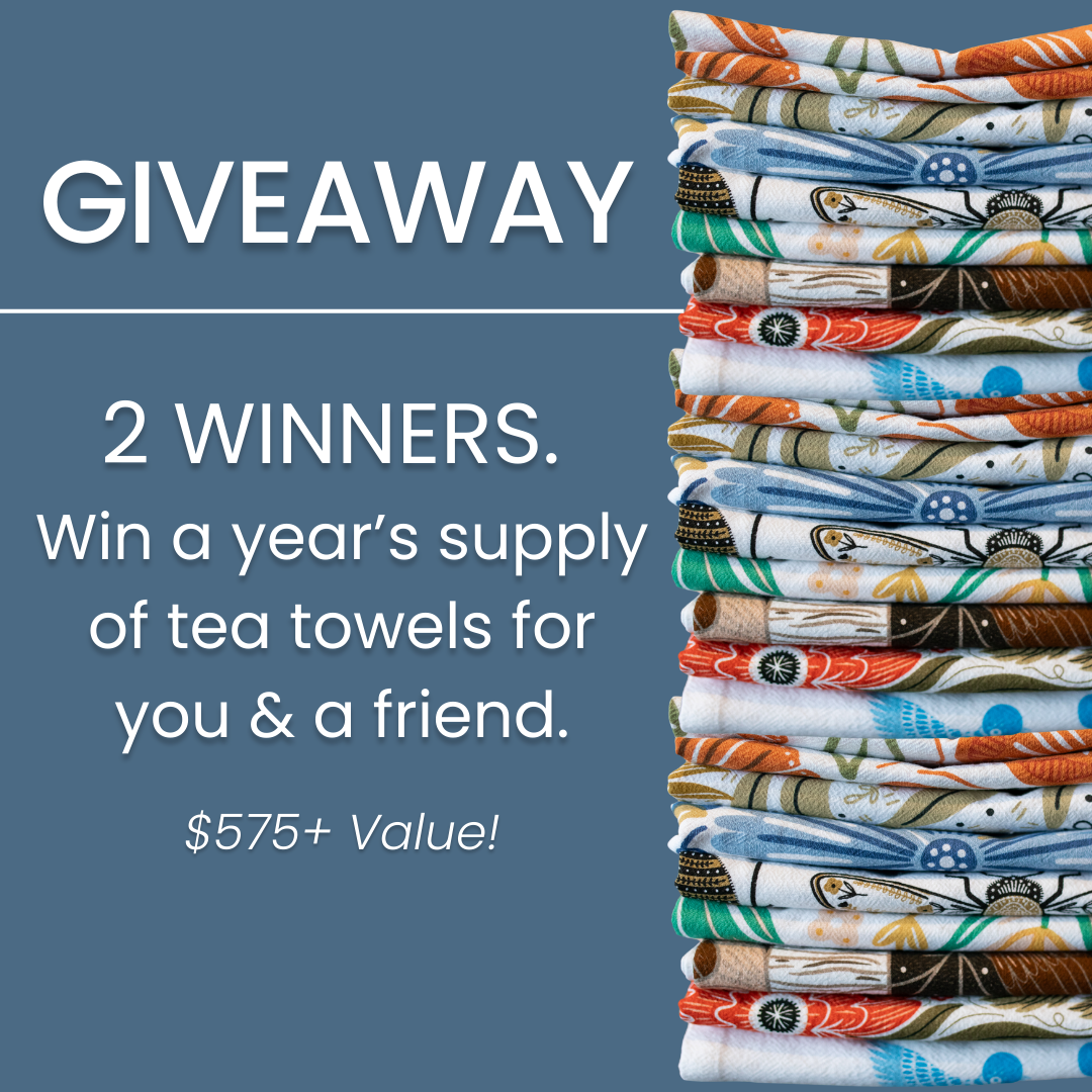 Stack of colorful tea towels with a giveaway announcement on a blue background