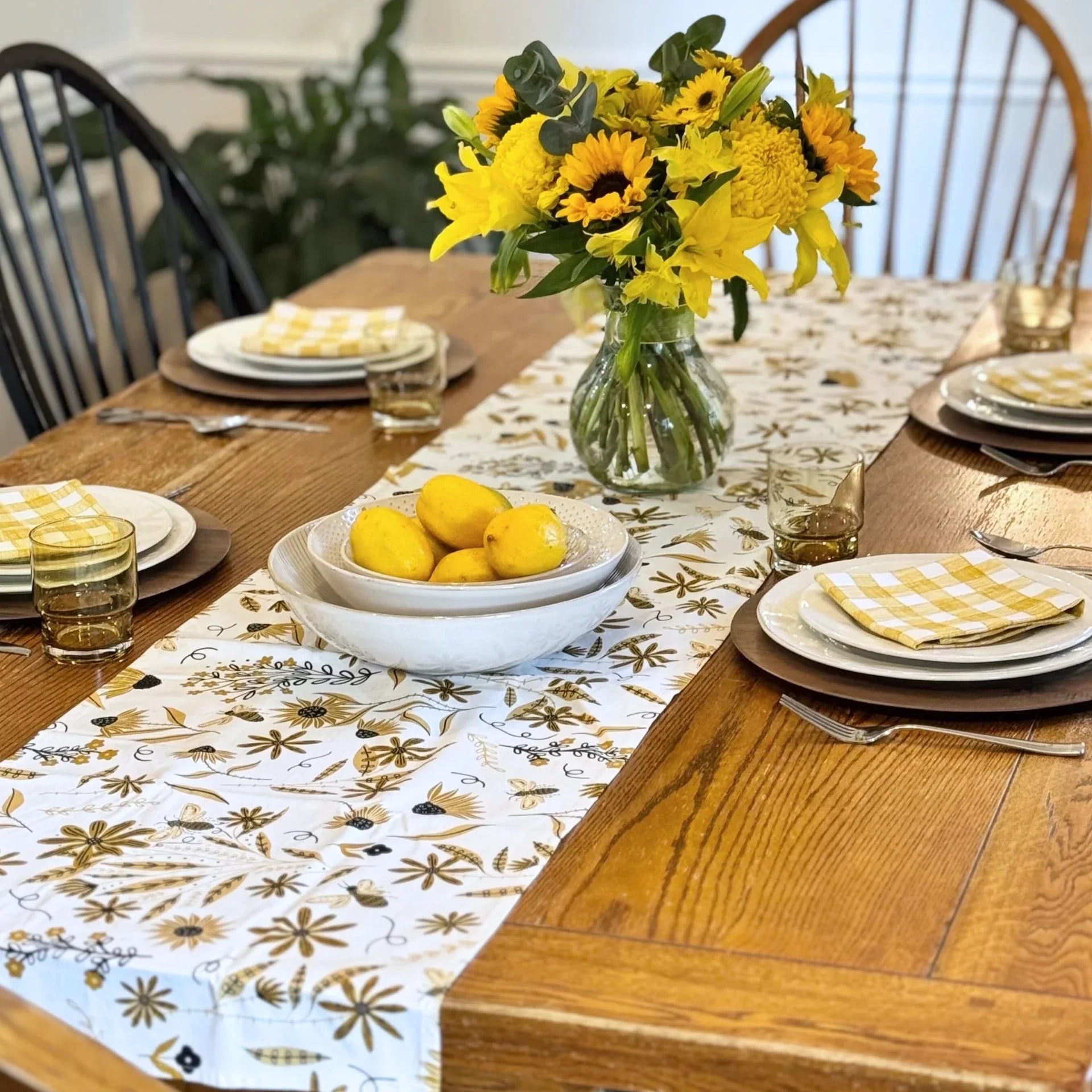 bundle of tabletop products - white table runner with bee and floral elements, gold gingham cloth napkins
