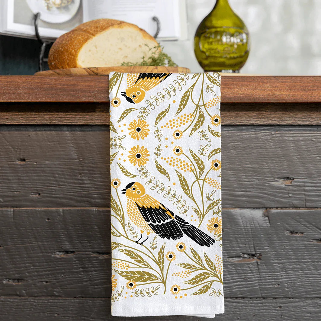 tea towel with illustrated birds and floral elements