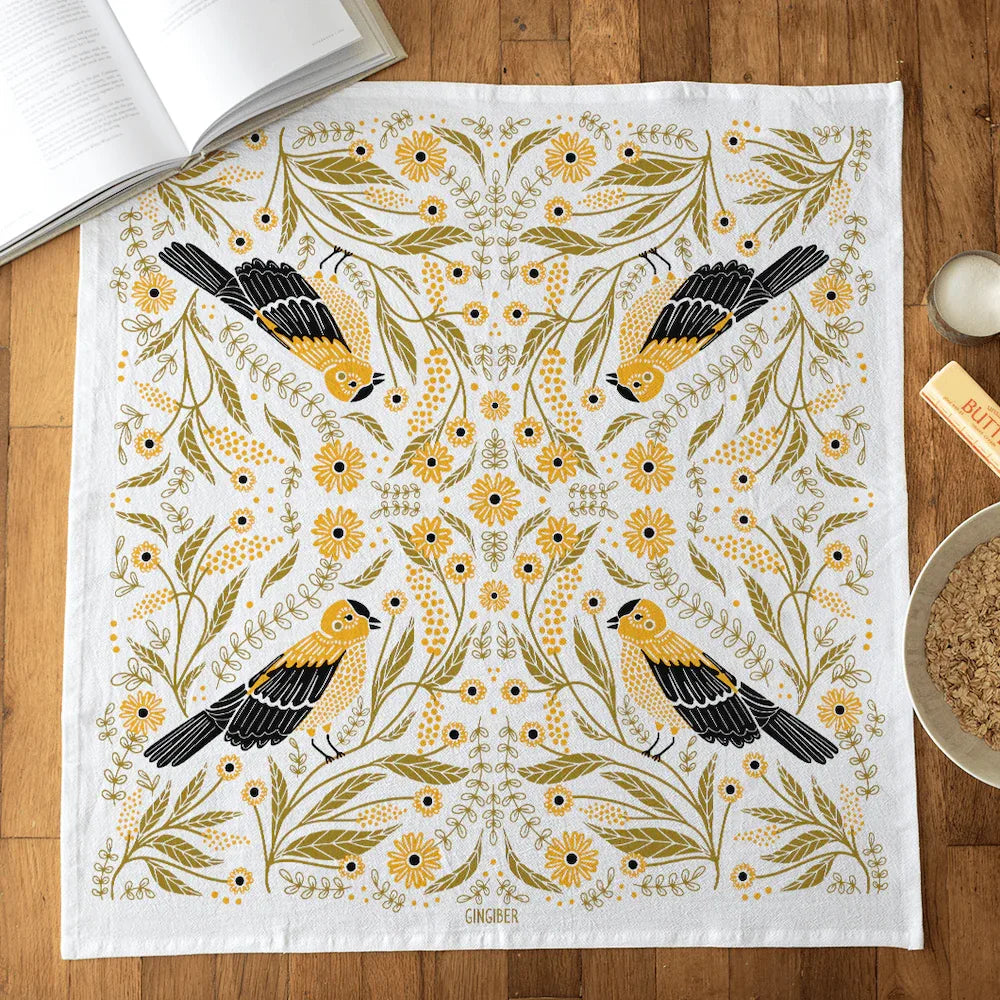 tea towel with illustrated birds and floral elements