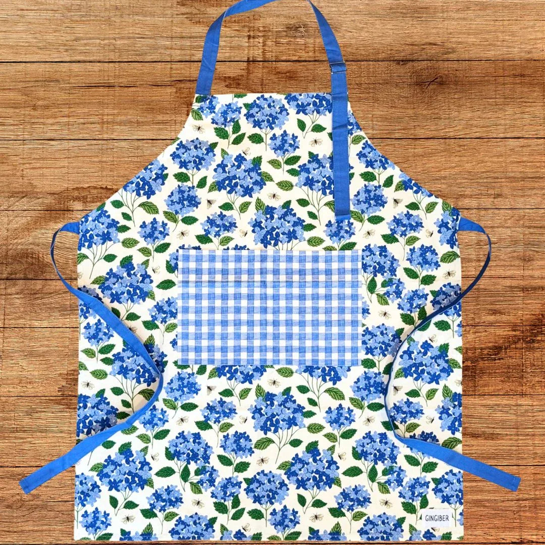 Hydrangea Apron—bake in style with gingiber apron featuring blue hydrangea print, adjustable neck strap, large pocket, 100% cotton canvas
