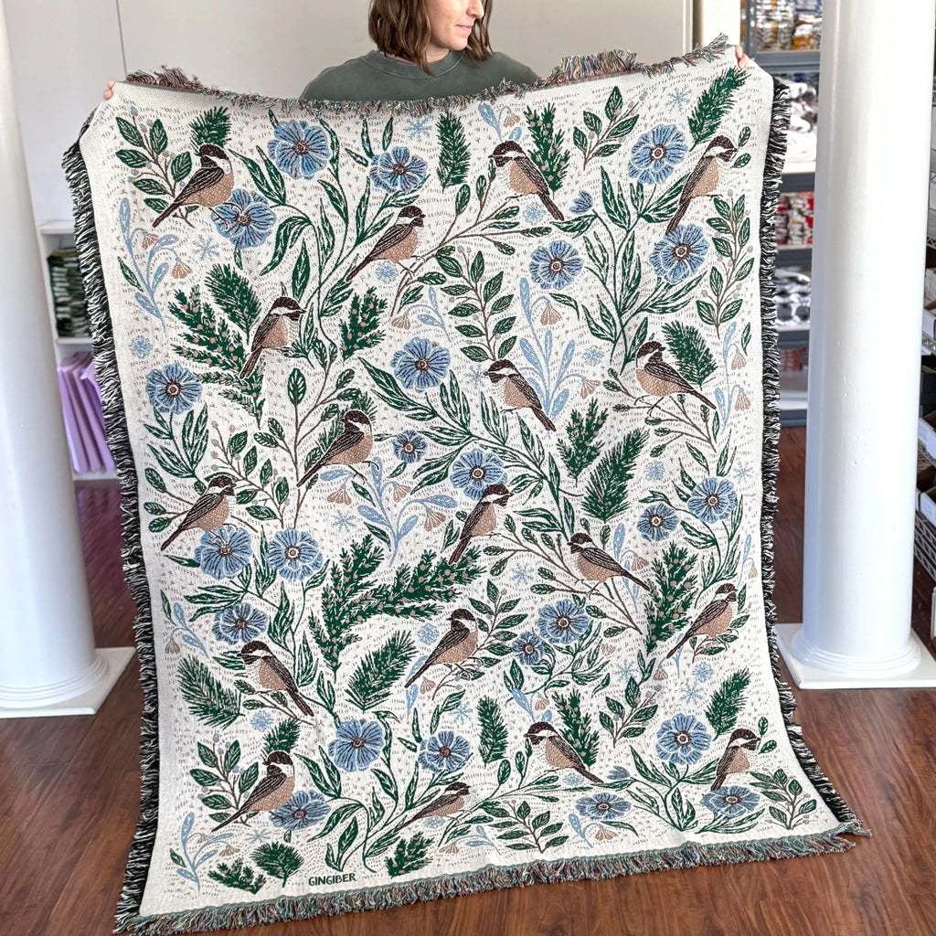 Blanket - woven throw featuring winter and forest animal illustrations on light background