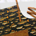 Patterned fabric with fish design and brown leather strap on a white background