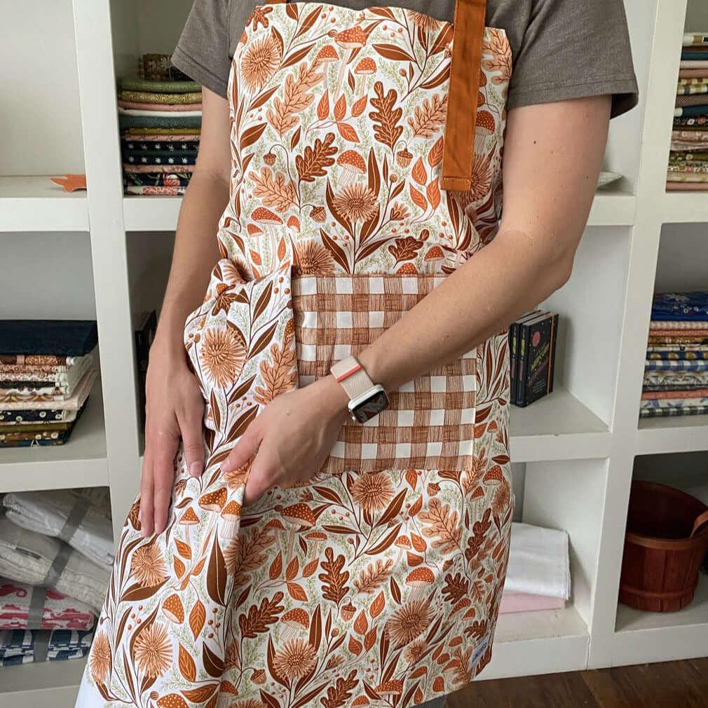 Mushroom Medley Apron & Tea Towel—bake in style with gingiber apron featuring mushroom illustrations and matching tea towel, adjustable neck strap, large pocket, 100% cotton canvas