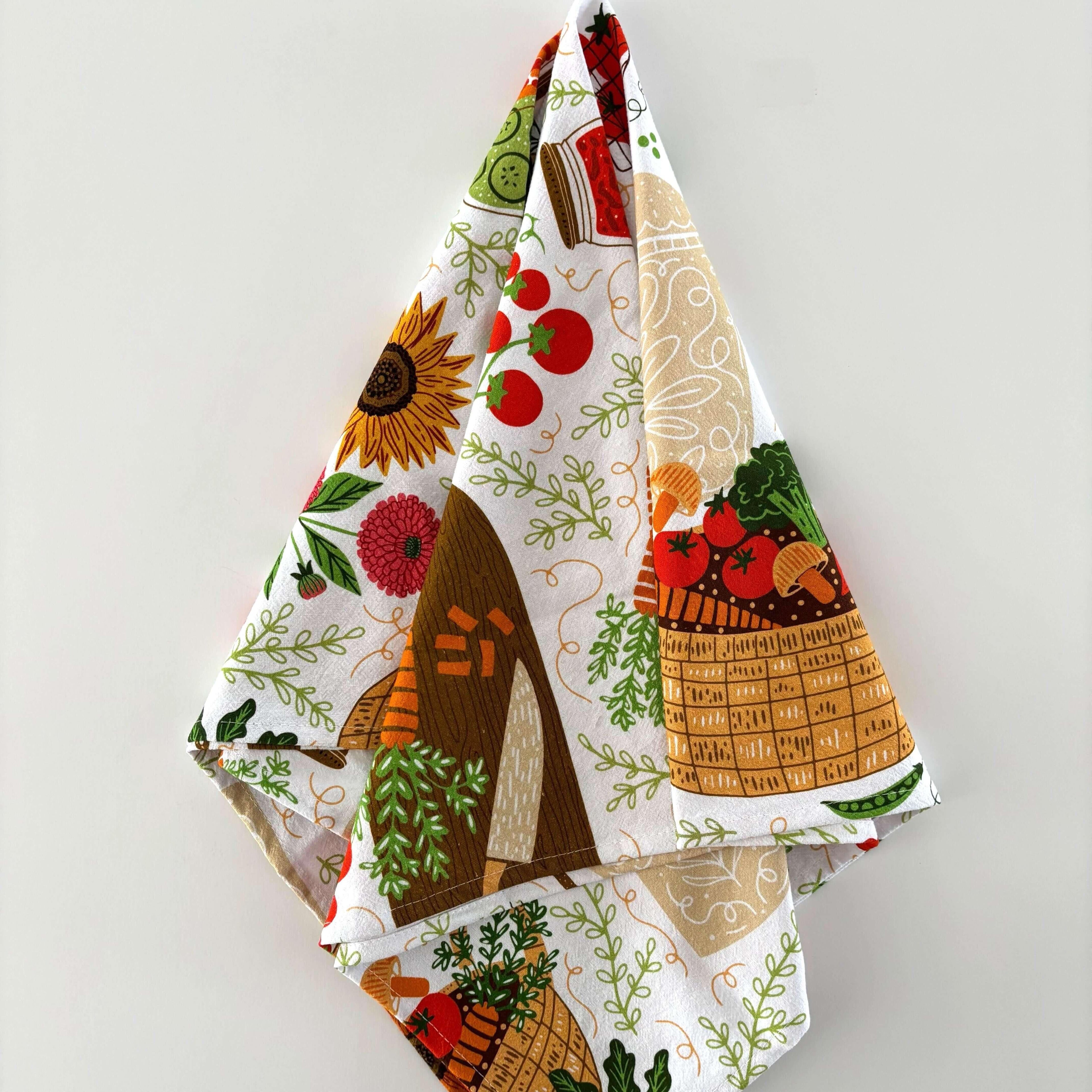 Decorative kitchen towel with farm-themed design on a white background