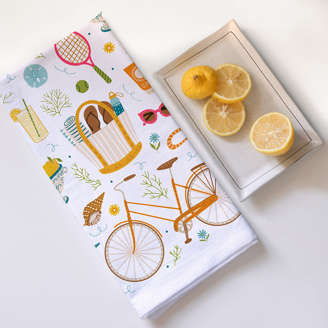 Notebook with bicycle design next to a plate of lemons on a light surface