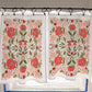 Floral patterned curtains hanging on a rod with a tiled wall background.