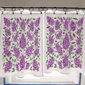 Two white towels with purple floral pattern hanging on a rack.