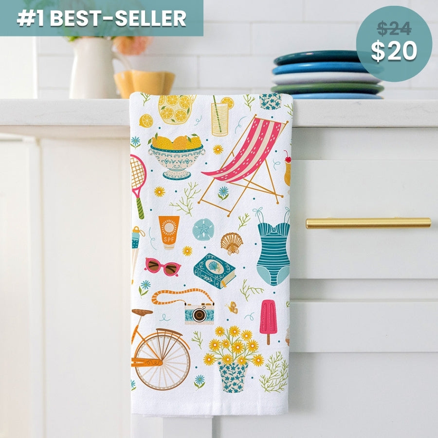Colorful towel with summer-themed designs hanging on a cabinet handle.