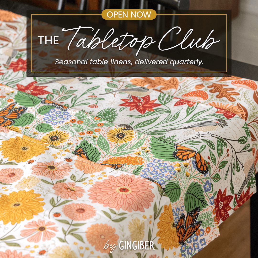 Floral tablecloth with butterflies and text about The Tabletop Club by Gingiber.