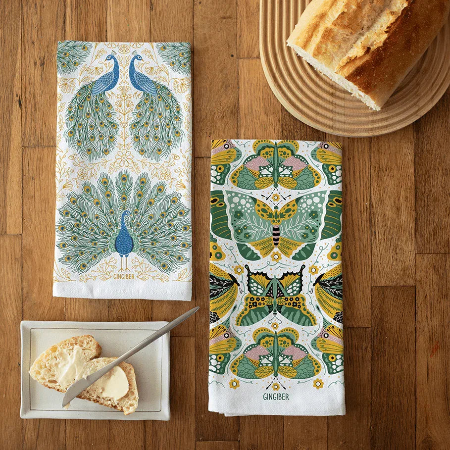 tea towel bundle with illustrations of peacocks, butterflies, and floral elements