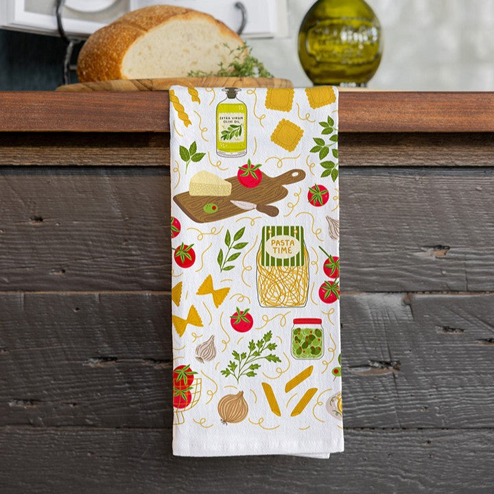Kitchen towel with food-themed design hanging on a wooden surface