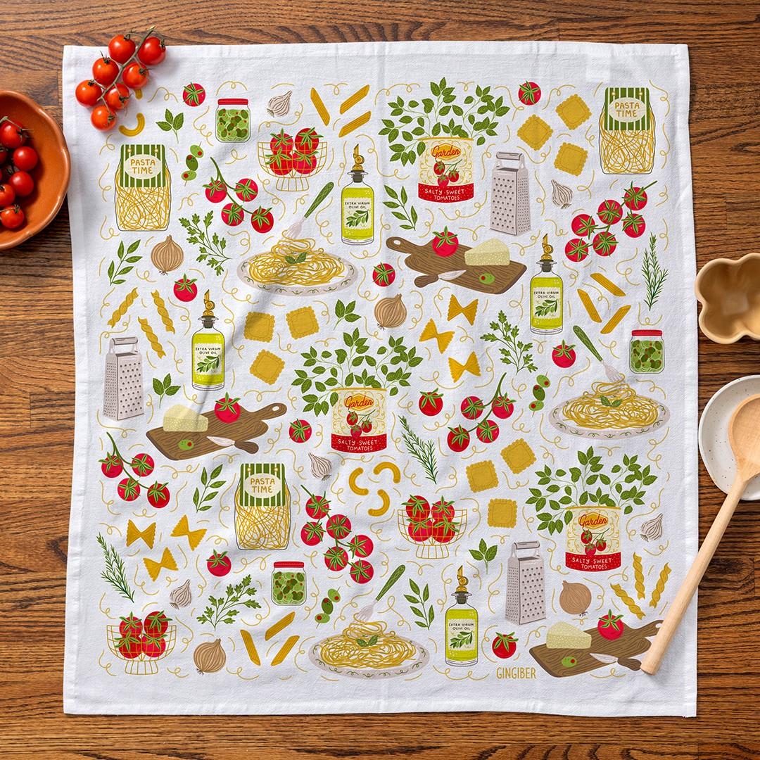 Tea towel with Italian food illustrations on a wooden table
